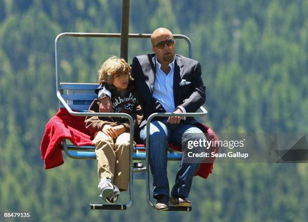 Luis Garcia Fanjul, best man at the wedding of Boris Becker, and Becker's younger son Elias ride a ski lift to the wedding brunch reception of former...