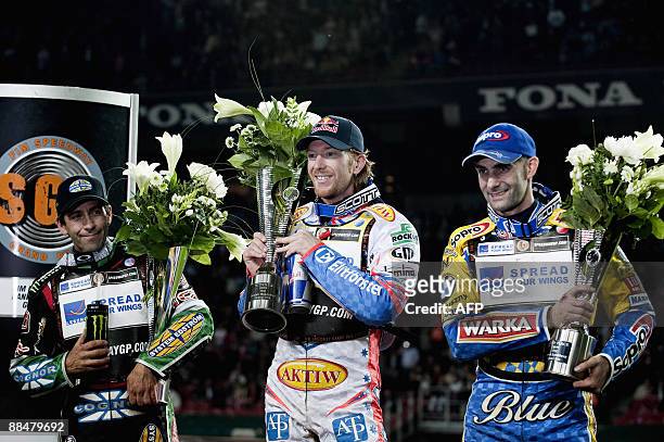Australian speedway rider Jason Crump stands on the winners podium with runner up Greg Hancock of the US and Tomasz Gollob of Poland who placed third...