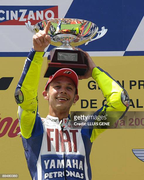 Yamaha's Italian Valentino Rossi celebrates on the podium of the Moto GP race of the Catalunya Grand Prix at the Montmelo racetrack on June 14, 2009...