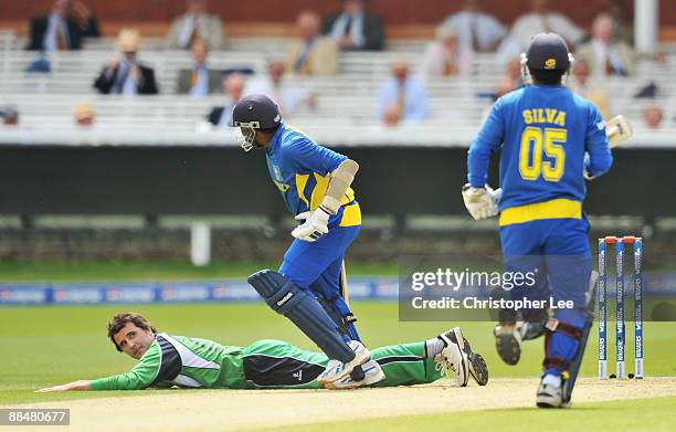 Kyle McCallan of Ireland looks back at Mahela Jayawardene and Chamara Silva of Sri Lanka as they run between the wickets during the ICC World...