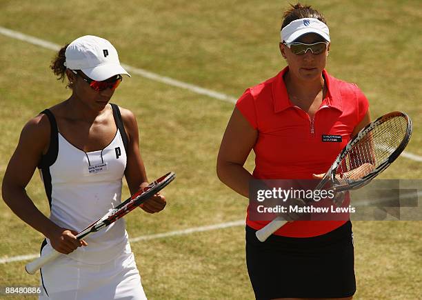 Raquel Kops-Jones and Abigail Spears of the United States in action against Liezel Huber of the United States and Cara Black of Zimbabwe during day...