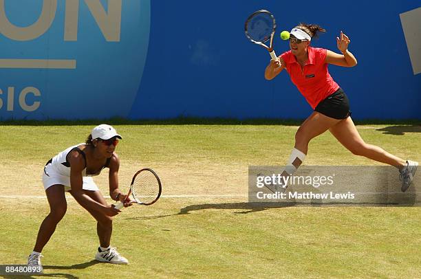 Raquel Kops-Jones and Abigail Spears of the United States in action against Liezel Huber of the United States and Cara Black of Zimbabwe during day...