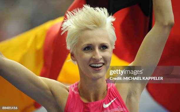 Germany's Ariane Friedrich celebrates with her national flag after winning the women's high jump event of the ISTAF Golden League athletics meeting...