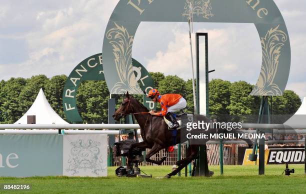 French jockey Christophe Lemaire crosses the finish line to win the 160th Prix de Diane horse racing with Stacelita, on June 14, 2009 in Chantilly, a...
