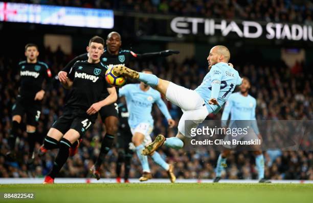 David Silva of Manchester City scores his sides second goal during the Premier League match between Manchester City and West Ham United at Etihad...
