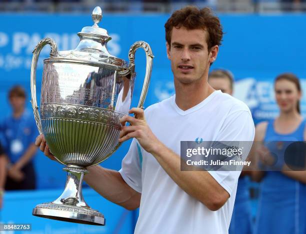 Andy Murray of Great Britain celebrates winning the match and the Championship with the trophy during the men's final match against James Blake of...