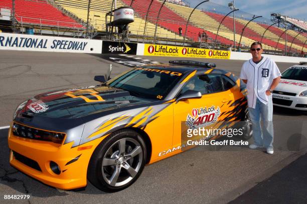 Jim Schwartz, Head Coach of the National Football League's Detroit Lions, poses in front of the pace car prior to the start of the NASCAR Sprint Cup...
