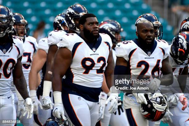 Nose tackle Zach Kerr of the Denver Broncos and free safety Darian Stewart of the Denver Broncos head to the locker room before the Broncos take on...