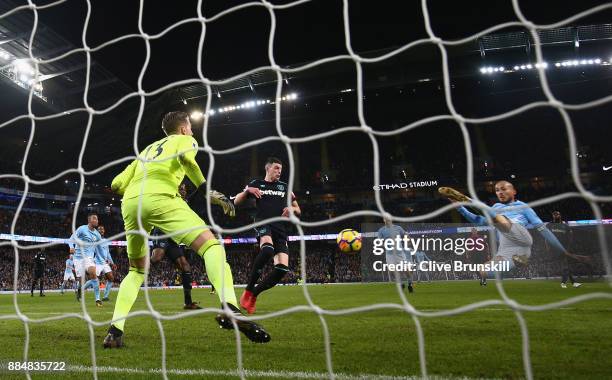 David Silva of Manchester City scores his sides second goal past Adrian of West Ham United during the Premier League match between Manchester City...