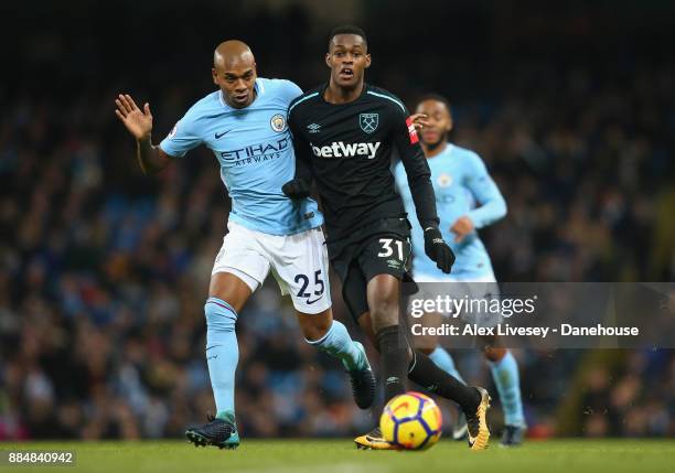 Edimilson Fernandes of West Ham United takes on Fernandinho of Manchester City during the Premier League match between Manchester City and West Ham...