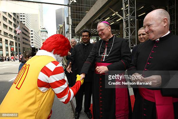 Archbishop Timothy Dolan shakes hands with Ronald McDonald during the 2009 Puerto Rican Day Parade on the streets of Manhattan on June 14, 2009 in...