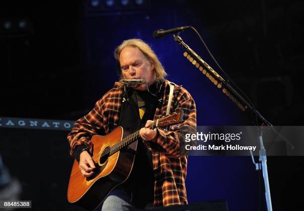 Neil Young performs on stage on day 3 of the Isle Of Wight Festival at Seaclose Park on June 14, 2009 in Newport, Isle of Wight.