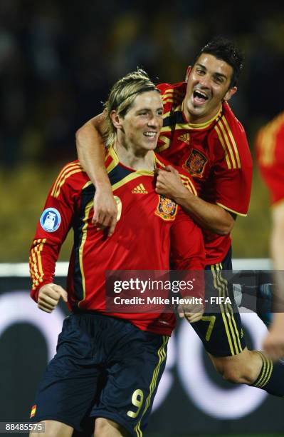 Fernando Torres of Spain celebrates his first goal with team mate David Villa during the FIFA Confederations Cup group match between New Zealand and...