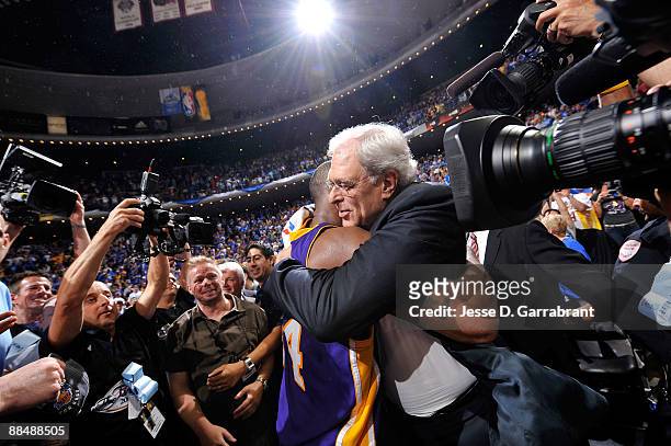 Kobe Bryant and head coach Phil Jackson of the Los Angeles Lakers celebrate after the Lakers won 99-86 to win the NBA Championship against the...