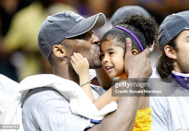 Kobe Bryant of the Los Angeles Lakers kisses his daughter, Gianna, after the Lakers defeated the Orlando Magic 99-86 in Game Five of the 2009 NBA...