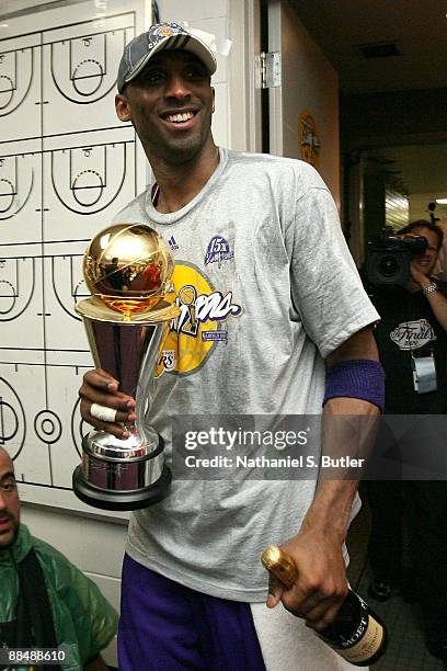 Finals MVP Kobe Bryant of the Los Angeles Lakers celebraters in the locker room with his MVP trophy after they won 99-86 to win the NBA Championship...