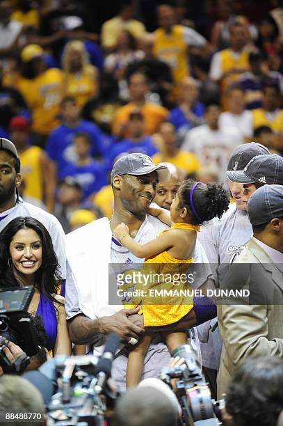 Kobe Bryant of the Los Angeles Lakers celebrates with his family at the end of Game 5 in the NBA Finals against the Orlando Magic at Amway Arena on...