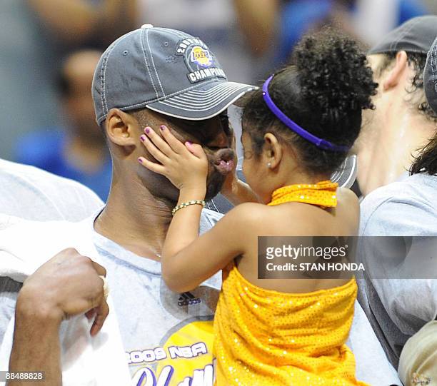 Kobe Bryant of the Los Angeles Lakers celebrates victory with his daughter following Game 5 of the NBA Finals against the Orlando Magic at Amway...