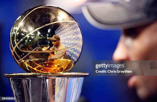 Kobe Bryant of the Los Angeles Lakers answers questions during the news conference with the Bill Russell MVP trophy after the Lakers defeated the...