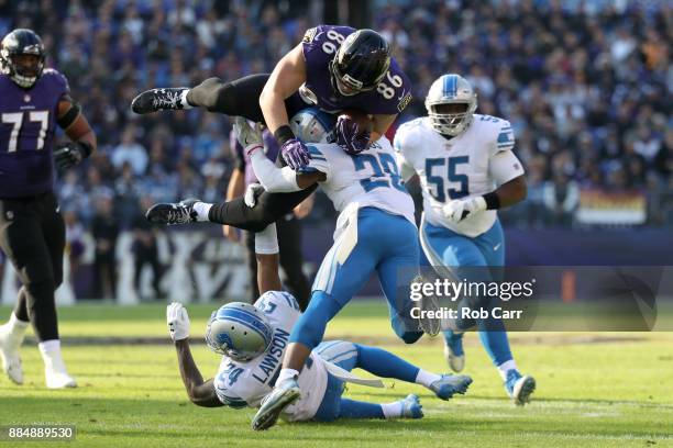 Tight End Nick Boyle of the Baltimore Ravens is tackled as he carries the ball by cornerback Quandre Diggs of the Detroit Lions in the first quarter...