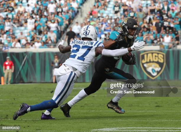 Keelan Cole of the Jacksonville Jaguars runs with the football against Nate Hairston of the Indianapolis Colts in the first half of their game at...