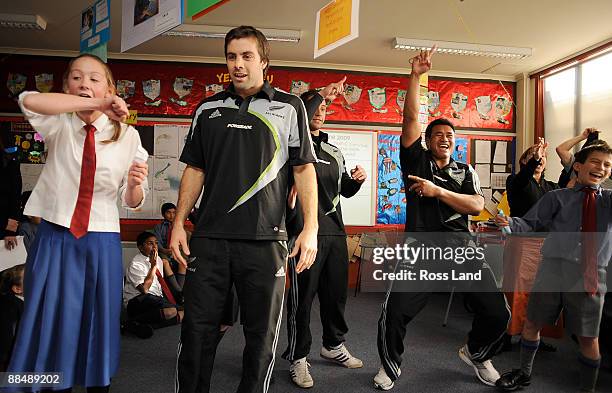 Conrad Smith, Luke McAlister and Isaia Toeava compete in a charades competition during a visit by the New Zealand All Blacks to St Mark's Church...