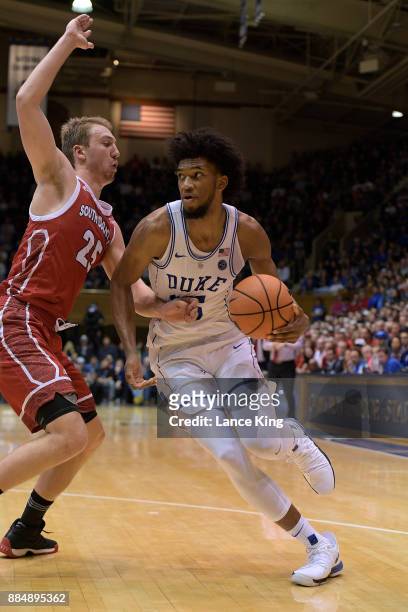 Marvin Bagley III of the Duke Blue Devils moves the ball against Tyler Hagedorn of the South Dakota Coyotes at Cameron Indoor Stadium on December 2,...