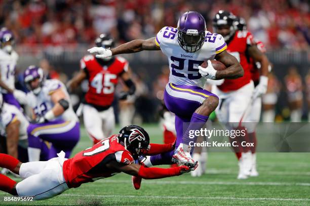 Latavius Murray of the Minnesota Vikings avoids the tackle by Damontae Kazee of the Atlanta Falcons on a long run during the first half at...