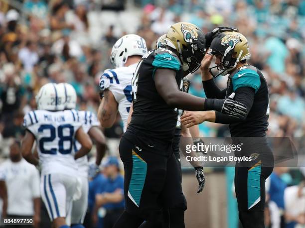 Josh Lambo of the Jacksonville Jaguars is greeted by Cam Robinson after Lambo hit a 30-yard field goal in the first half of their game against the...