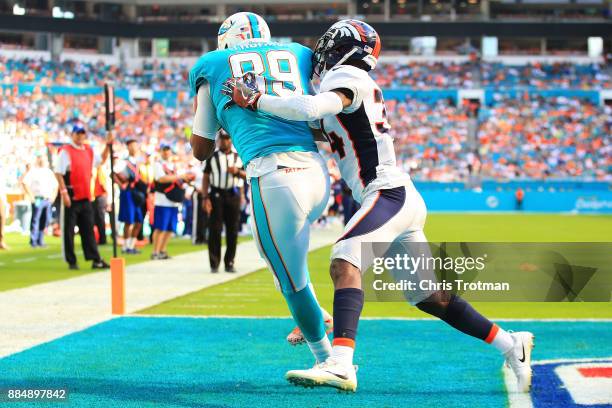 Julius Thomas of the Miami Dolphins makes the catch for a touchdown in the second quarter against Will Parks of the Denver Broncos at the Hard Rock...