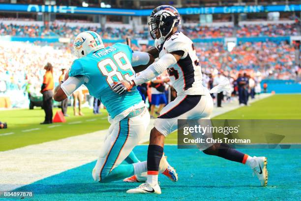 Julius Thomas of the Miami Dolphins makes the catch for a touchdown in the second quarter against Will Parks of the Denver Broncos at the Hard Rock...