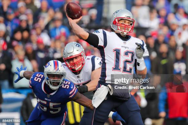 Jerry Hughes of the Buffalo Bills attempts to sack Tom Brady of the New England Patriots as he throws the ball during the first quarter on December...