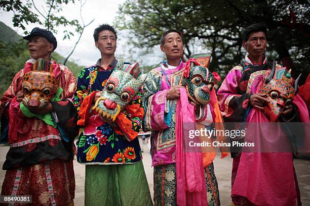 Baima people prepare to perform the Zhou Dance at the Yinggema Village on June 14, 2009 in Jiuzhaigou County of Sichuan Province, China. Baima is a...
