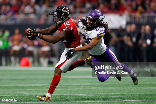 Mohamed Sanu of the Atlanta Falcons makes a catch against Trae Waynes of the Minnesota Vikings during the first half at Mercedes-Benz Stadium on...