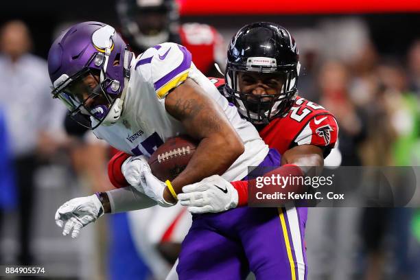 Jarius Wright of the Minnesota Vikings is tackled by Keanu Neal of the Atlanta Falcons after a catch during the first half at Mercedes-Benz Stadium...