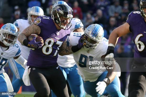 Tight End Nick Boyle of the Baltimore Ravens runs with the ball in the second quarter as he is tackled by defensive tackle A'Shawn Robinson of the...