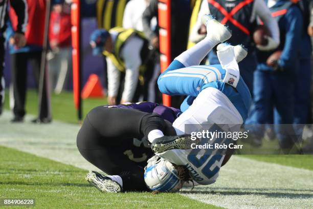 Running Back Tion Green of the Detroit Lions is tackled in the first quarter by free safety Eric Weddle of the Baltimore Ravens at M&T Bank Stadium...