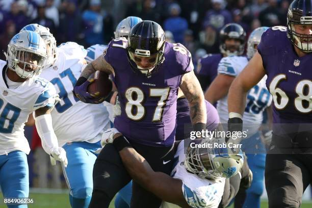 Tight End Nick Boyle of the Baltimore Ravens runs with the ball in the second quarter as he is tackled by defensive tackle A'Shawn Robinson of the...