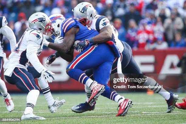 Malcolm Butler of the New England Patriots and David Harris of the New England Patriots tackle LeSean McCoy of the Buffalo Bills during the second...