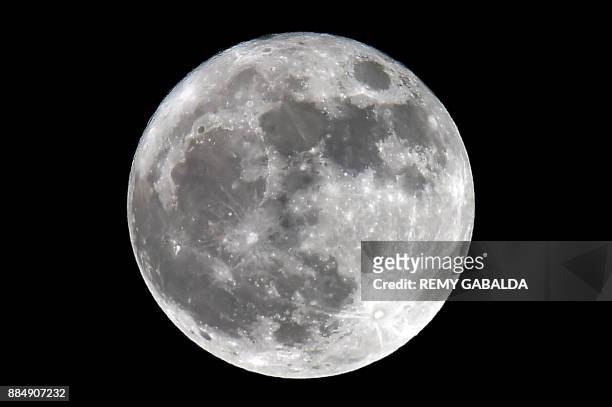 Picture shows a "supermoon", seen from Trebons-sur-la-Grasse, southern France, on December 3, 2017. The lunar phenomenon occurs when a full moon is...