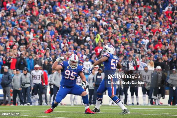 Kyle Williams of the Buffalo Bills and Jerry Hughes of the Buffalo Bills celebrate during the second quarter after Williams sacked Tom Brady of the...