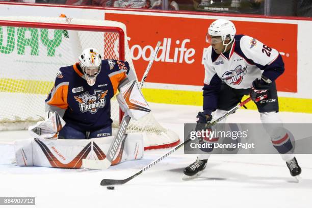 Goaltender Luke Cavallin of the Flint Firebirds defends the net against forward Cole Purboo of the Windsor Spitfires on December 3, 2017 at the WFCU...