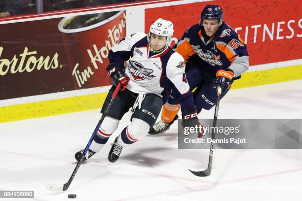 Defenceman Nathan Staios of the Windsor Spitfires moves the puck against forward Ty Dellandrea of the Flint Firebirds on December 3, 2017 at the WFCU...