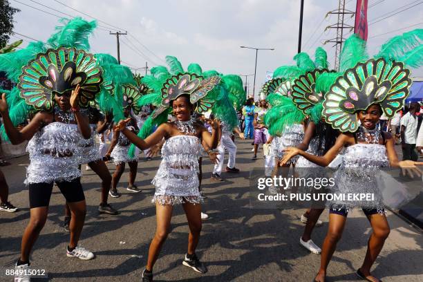 Cultural troupe dances during the Lagos Street Carnival on December 3 in Lagos. Commercial activities in the burstling Ikeja district of Lagos were...