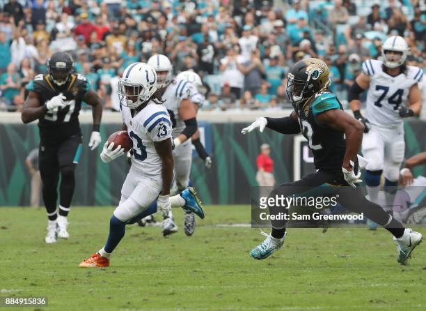 Hilton of the Indianapolis Colts runs for a 40-yard touchdown past Barry Church of the Jacksonville Jaguars in the second half of their game at...