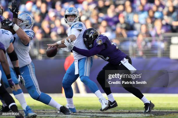 Quarterback Matthew Stafford of the Detroit Lions is hit as he throws by free safety Eric Weddle of the Baltimore Ravens at M&T Bank Stadium on...