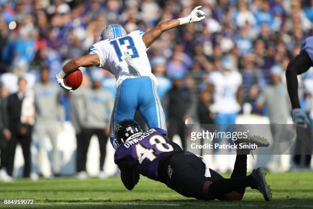 Wide Receiver T.J. Jones of the Detroit Lions is tackled by inside linebacker Patrick Onwuasor of the Baltimore Ravens in the second quarter at M&T...