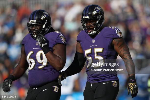 Outside Linebacker Terrell Suggs and defensive tackle Willie Henry of the Baltimore Ravens walk off the field in the first quarter against the...