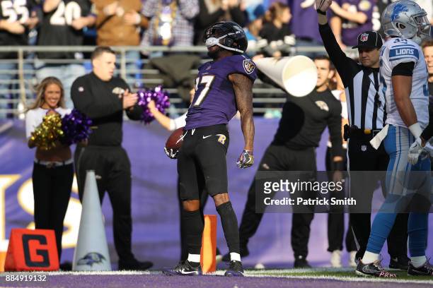 Wide Receiver Mike Wallace of the Baltimore Ravens reacts after catching a pass in the second quarter against the Detroit Lions at M&T Bank Stadium...