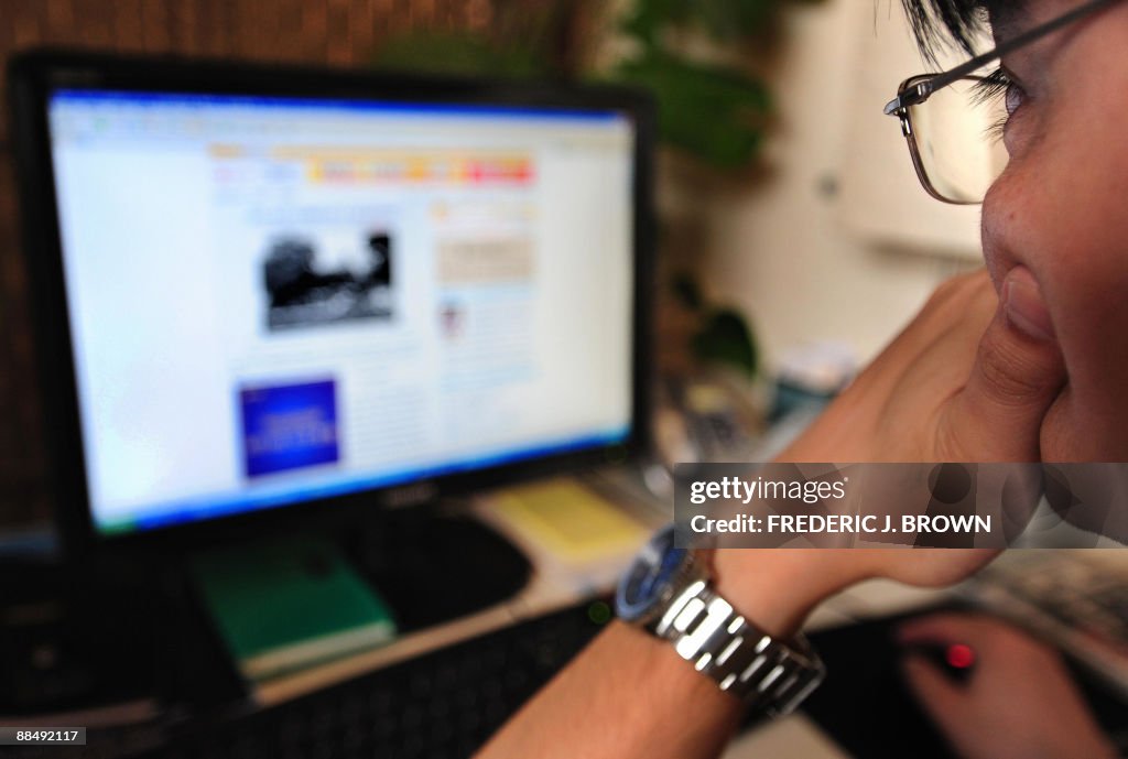 A man surfs the internet in Beijing on J
